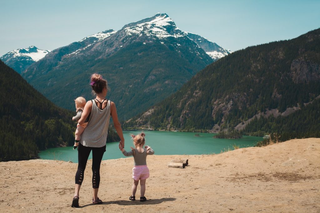 Family and kids standing in front of mountain