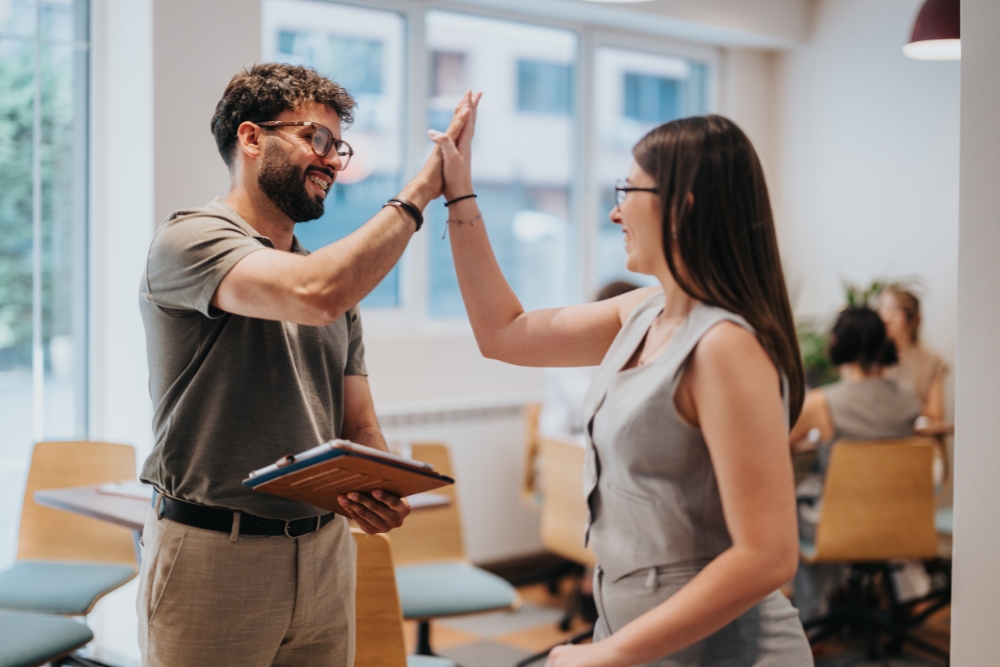 Coworkers high-fiving